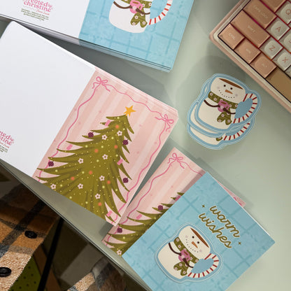 Collection of Christmas-themed greeting cards and coasters on a surface.