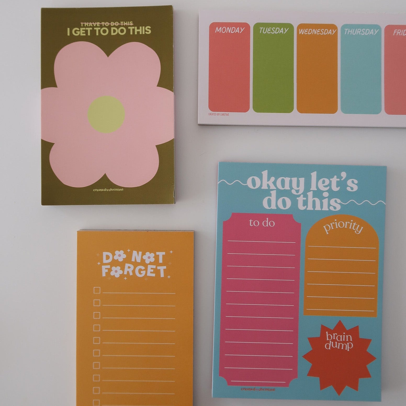 Set of colorful to-do list pads with different designs on a white background