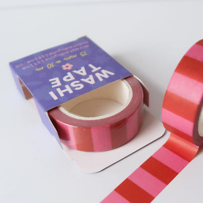 Striped washi tape with a purple packaging on a white background